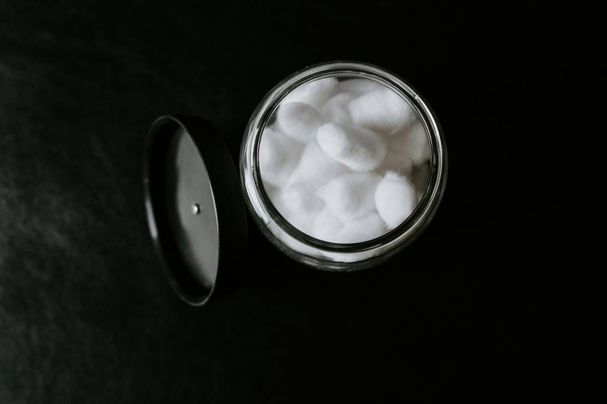Woman holding eco-friendly pads for sensitive skin with ingredient transparency label