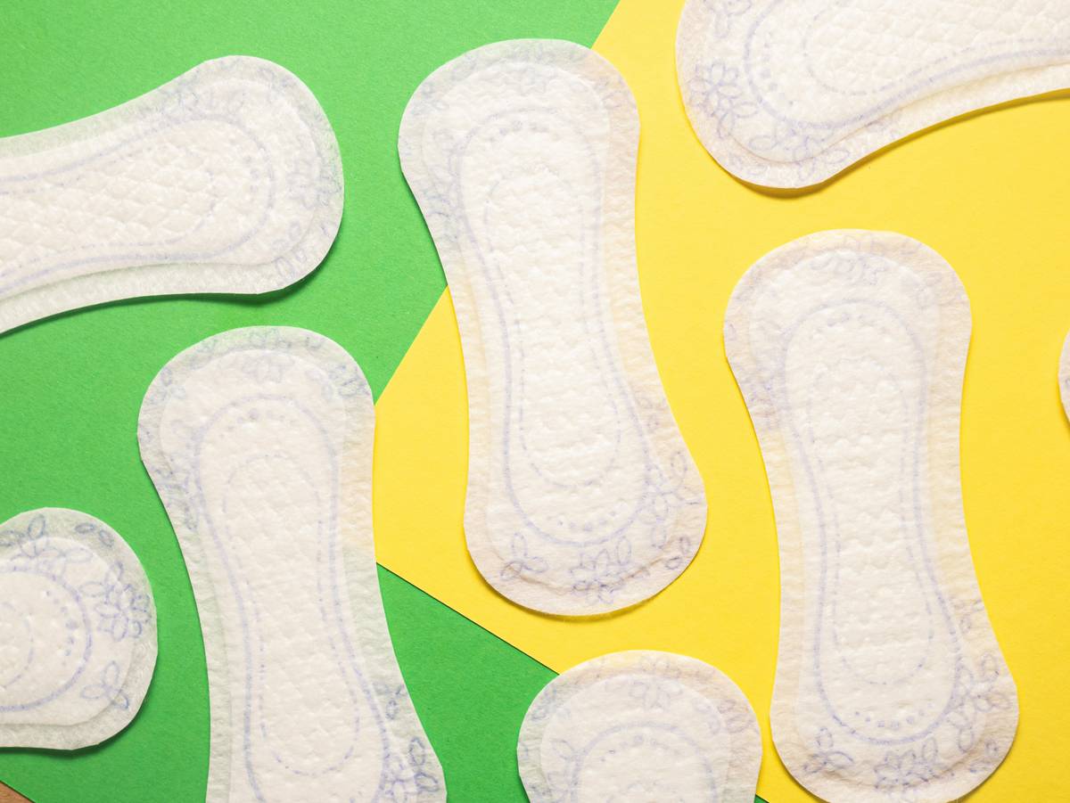 Woman comparing ingredient lists on scented pads packaging – are scented pads bad